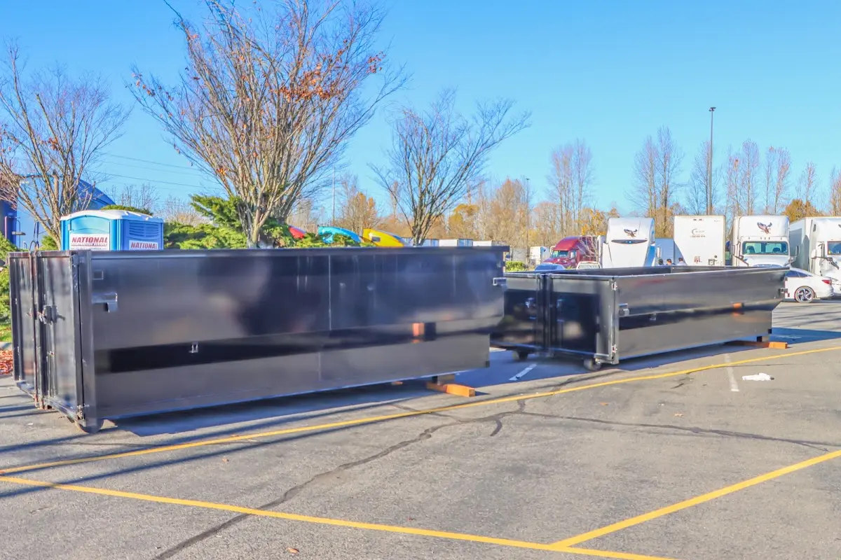 Professional dumpster rental service with roll-off container on residential driveway in Rosemont